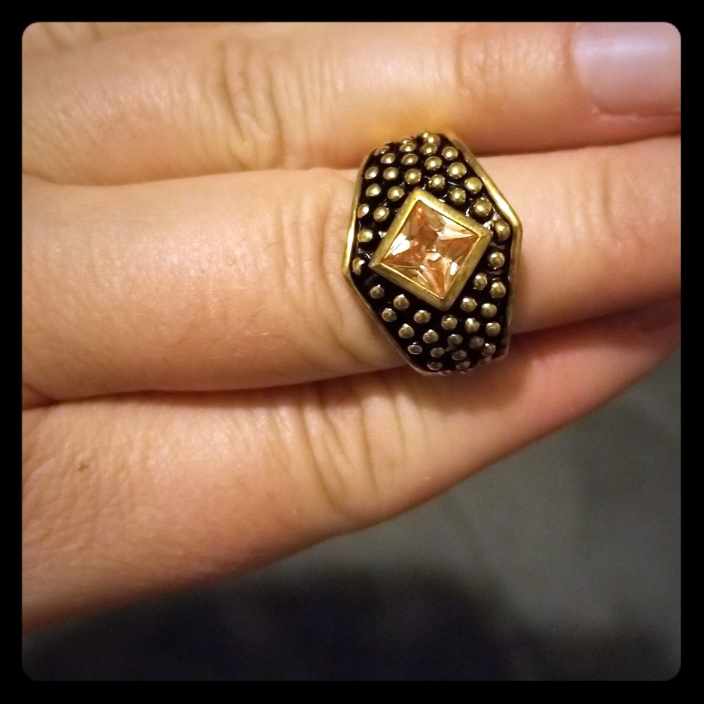 Womens pink stone gold colored ring.